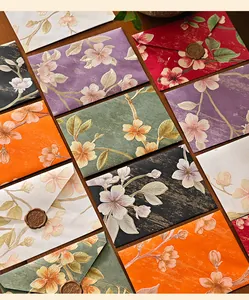High-detail macro view of vintage embossed floral envelopes in assorted colors for invitations