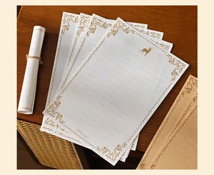 Detail of retro embossed floral pattern and golden deer logo on premium writing paper