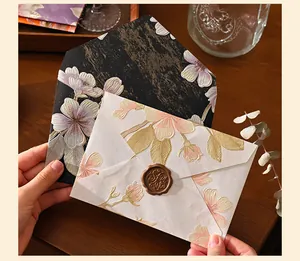 Close-up detail of vintage embossed floral pattern envelopes with a classic brown wax seal