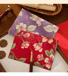 Close-up of vintage embossed floral envelopes in red and purple colors
