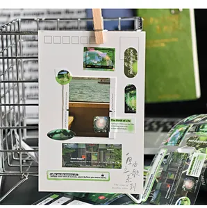 Close-up detail showing green-themed aesthetic PET stickers applied to a white card for journaling