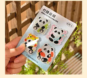 Set van 4 panda acryl koelkastmagneten vastgehouden tegen een zonnige achtergrond