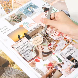 Detail view of person placing a "You are the best" sticker in a DIY vision board book.