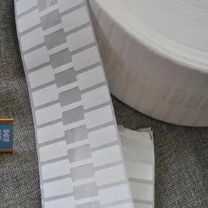 Close-up detail of white barbell shaped thermal synthetic paper jewelry price tags on a roll