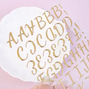 Detailed macro view of 3D gold embossed alphabet stickers with a shiny metallic finish