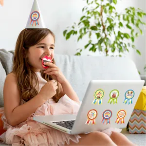 Happy birthday ribbon badge stickers for kids party decorations shown on a laptop lid