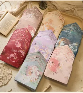 Overhead shot showing various vintage floral embossed envelopes in stacked arrangement
