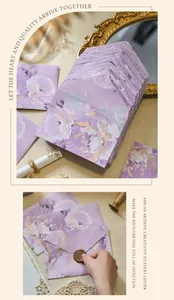 Detail of purple vintage floral envelope being sealed with a golden wax stamp.