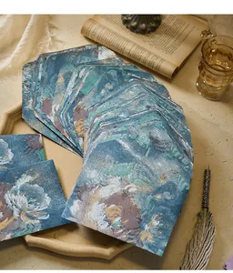 Macro shot showing the vintage oil painting floral texture and gold accents on these envelopes.