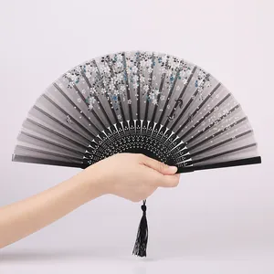 Elegant Chinese folding fan with floral pattern and black tassel for traditional outfits.
