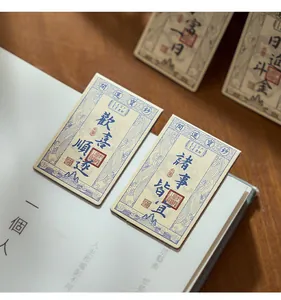 Close-up of Chinese-style magnetic bookmarks with traditional silver note motifs