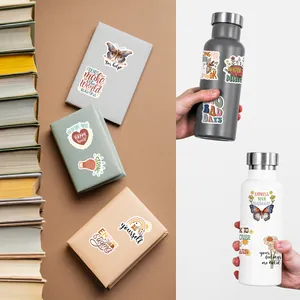 Inspirational mental health stickers on notebooks and water bottles for motivation.