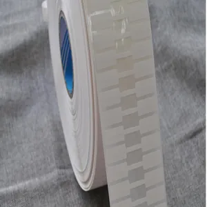 Close-up detail of a professional roll of white thermal jewelry labels in synthetic paper