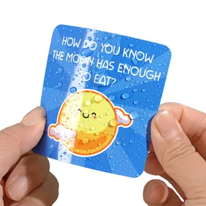 Close-up of waterproof inspirational lunch box note card with a cute moon joke design