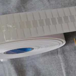 Macro view of white thermal jewelry labels on a roll for pricing and product tagging.