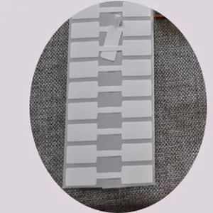 Detailed shot of white self-adhesive thermal jewelry labels in dumbbell shape for tags
