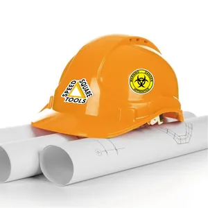 Close-up of waterproof industrial warning stickers applied on a yellow construction hard hat