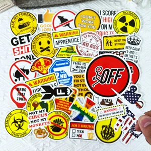 Close-up of industrial waterproof stickers for helmets and toolboxes with warning signs.