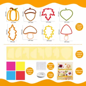 Detailed view of DIY window art kit including autumn shapes, colorful paper, and glue dots.