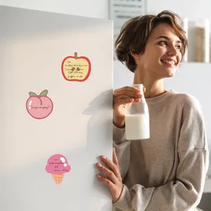 Lifestyle detail of cute fruit-shaped sticky notes on a refrigerator door