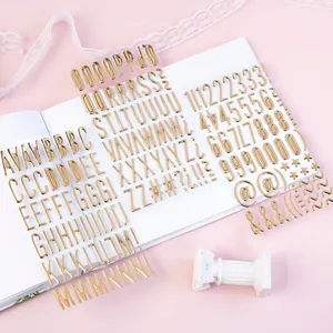 Macro detail of golden 3D metallic alphabet and number stickers for DIY scrapbooking