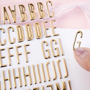Macro detail of 3D gold alphabet bubble stickers with premium metallic glossy finish