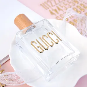 Detailed macro view of gold 3D metallic alphabet stickers applied to a glass bottle