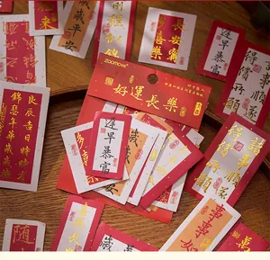 Gedetailleerde macro-opname van Chinese kalligrafiestickers met elegante goudfolie letters.