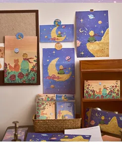 Close-up view of The Little Prince themed oil painting postcards and envelopes stationery