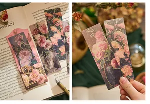 Artistic floral PVC bookmarks with gold foil detailing in a vintage book setting.
