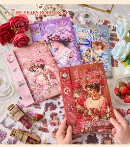 Close-up view of vintage floral sticker books featuring elegant Victorian-style portraits.