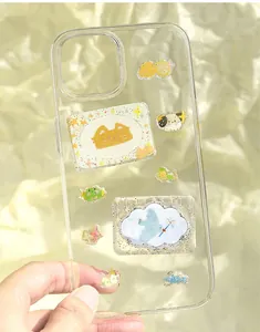 Close-up of cute cartoon PET epoxy stickers decorated on a clear smartphone case