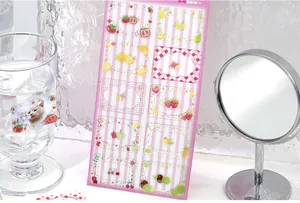 Cute PET crystal epoxy sticker sheet with pink frames shown with lifestyle props