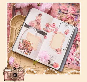Close-up of vintage girl and cake stickers used in a grid notebook