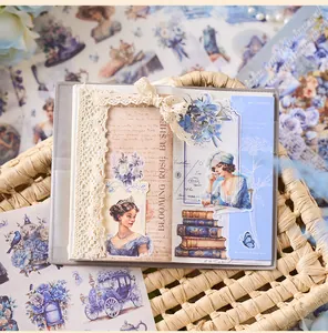 Close-up detail of vintage girl and floral stickers decorated on a creative DIY scrapbook page.