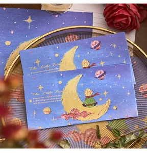 Detailed view of The Little Prince themed blue envelopes featuring oil painting style moon and stars