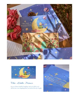 Macro detail of The Little Prince themed stationery envelopes with elegant foil lettering