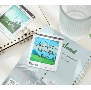 Detail view of a minimalist PET reversal film style keychain featuring a scenic landscape design