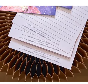 Close-up of lined letter paper with printed quotes on a honeycomb paper background