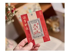 Detail view of a Chinese-style acrylic fridge magnet with a lucky silver note design.