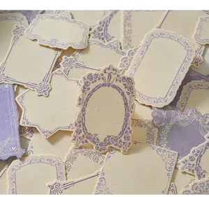 Detailed macro view of vintage floral embossed journal labels with purple borders