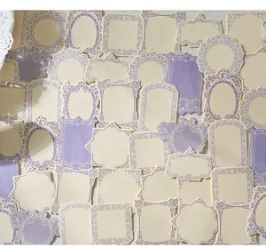 Detailed view of vintage purple and cream embossed labels for scrapbooking and journaling