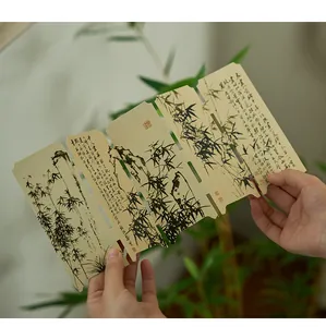 Close-up of traditional Chinese style folding paper bookmark with ink bamboo and calligraphy