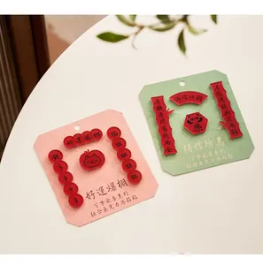 Close-up of red acrylic Chinese calligraphy refrigerator magnets on display card