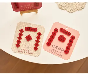 Close-up of red acrylic refrigerator magnets with Chinese calligraphy on cards.