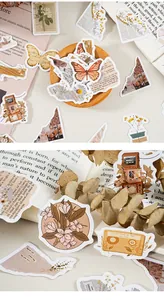 Close-up of vintage floral stickers with butterfly and cassette designs for journaling