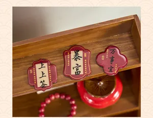 Traditional Chinese calligraphy epoxy refrigerator magnets displayed on a wooden shelf