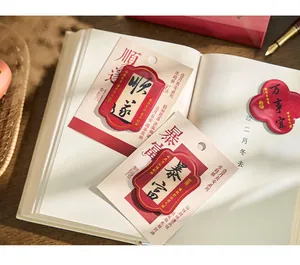 Detailed close-up of Chinese calligraphy fridge magnets on a book with fountain pen