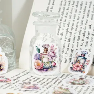 Vintage perfume bottle and flower stickers on a glass jar for DIY scrapbooking decoration