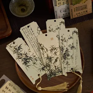 Chinese style ink painting paper bookmarks with elegant tassels in a wooden tray